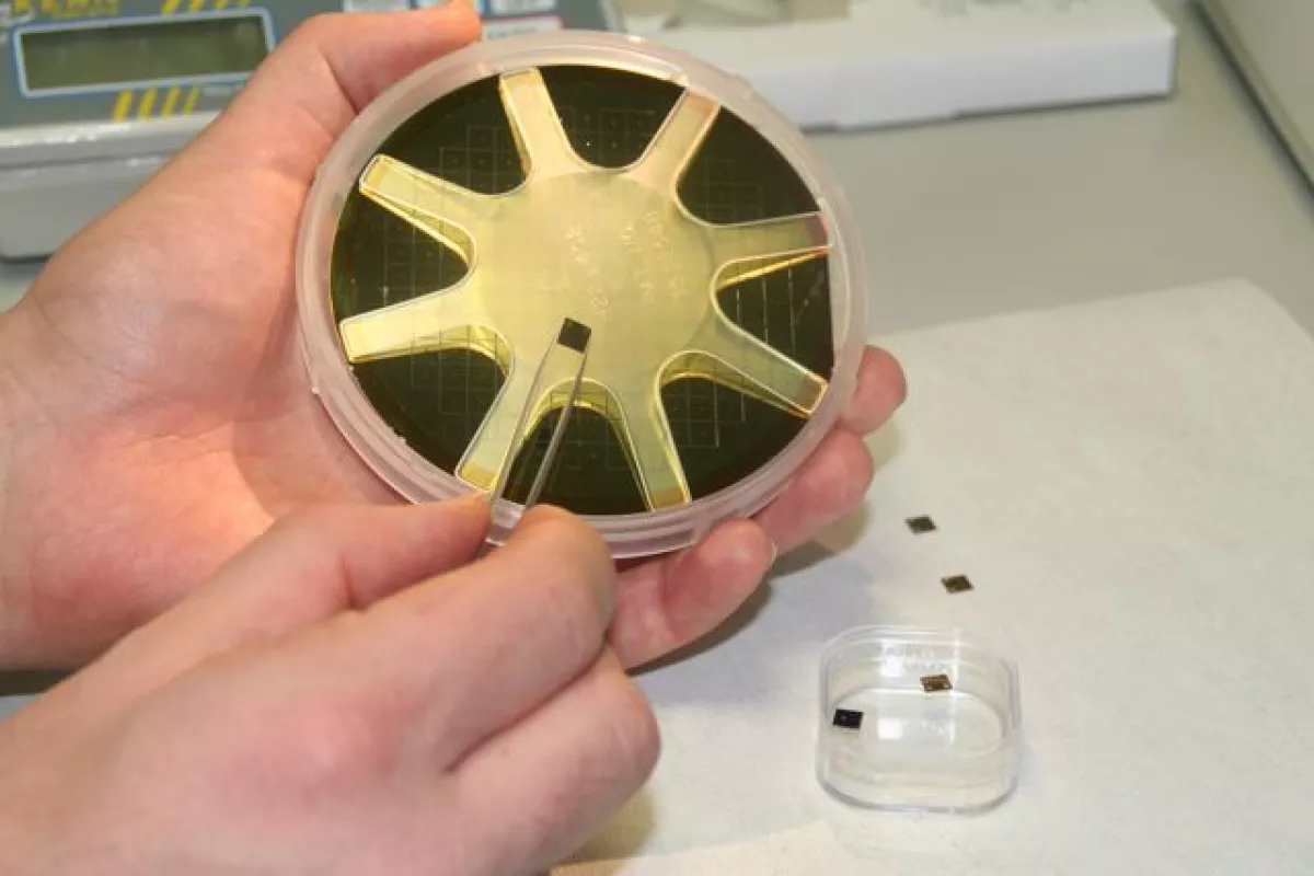 One of the DNA-reading chips, displayed against the prototype device (Photo: Imperial College London)