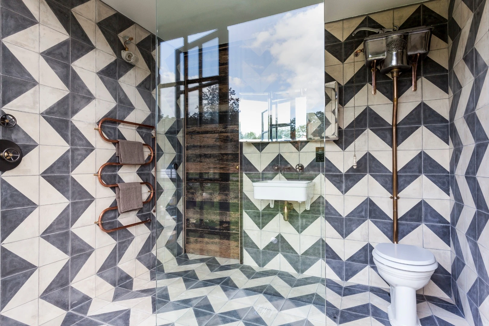 The tiny home also includes a central bathroom with retractable wall for showering in the open