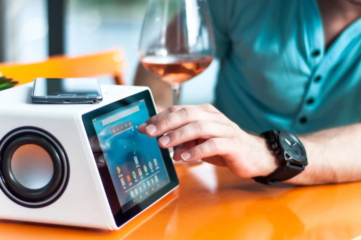 The Aivia smart speaker can be voice-controlled, features a touchscreen display panel, can wirelessly charge devices placed up top and has a B&O-designed subwoofer to the rear