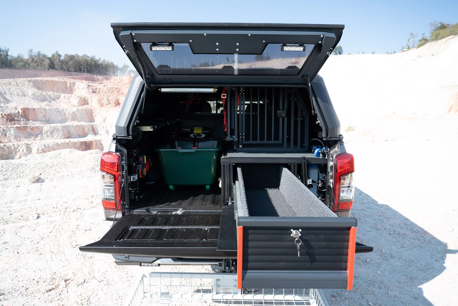 The gun drawer keeps firearms secure, while the dog crate keeps a hunting companion safe and secure