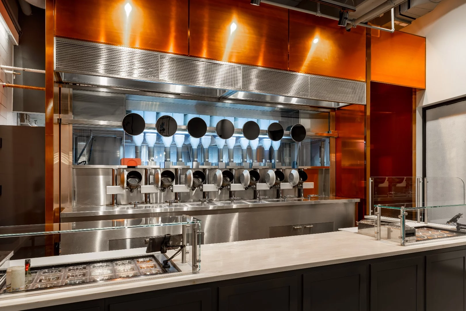 Dishes at Spyce are cooked within view of customers, in seven induction-heated rotating woks