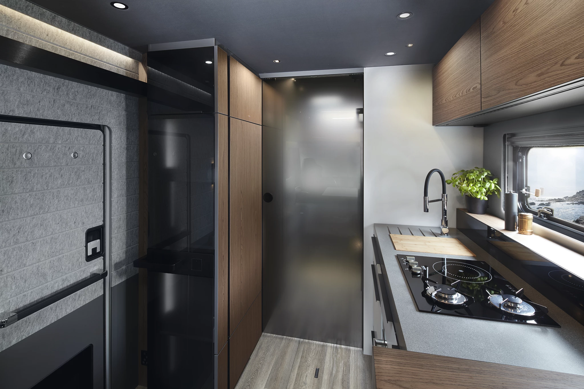 This smoked-glass door creates an en suite in back, separating off the rest of the motorohome