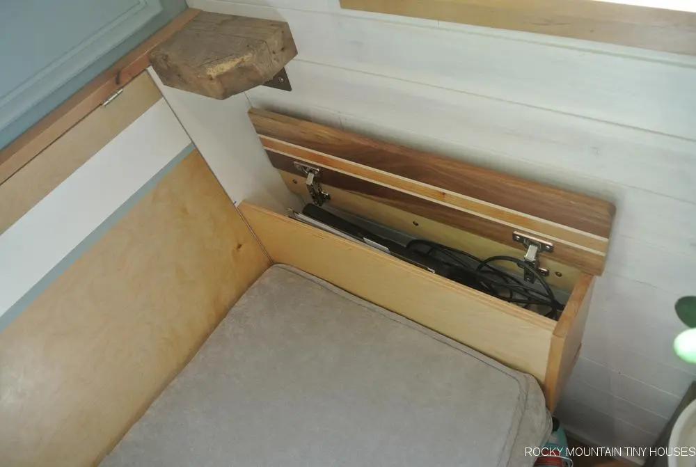 The San Juan Tiny House's sofa features arm rests with built-in laptop storage space