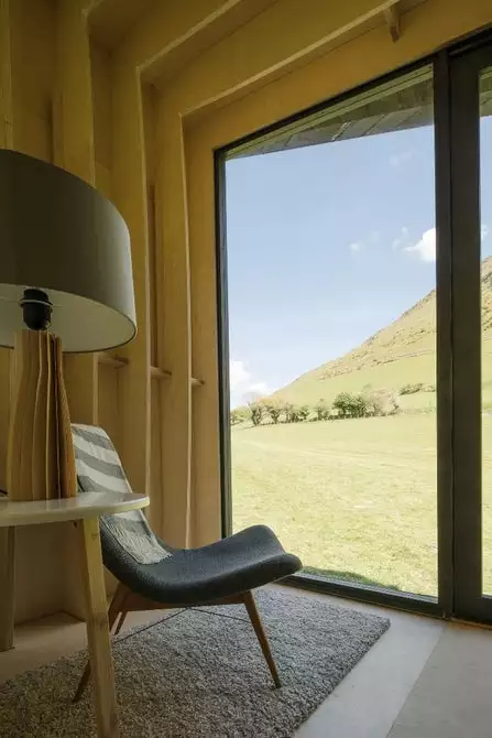 A floor to ceiling glass door allows occupants to enjoy stunning views of the surrounding landscape