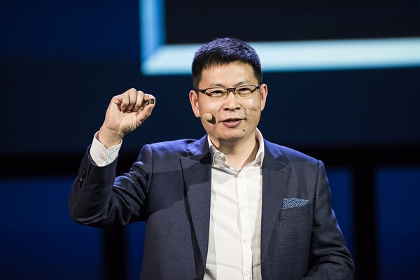 Huawei CEO Richard Yu, holding up a Kirin 970 chip