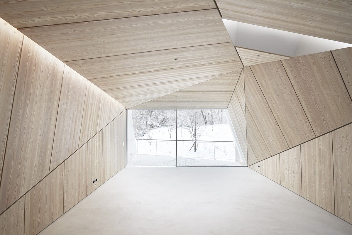 Wooden panels elegantly frame the large floor-to-ceiling window, transforming the view into a work of art