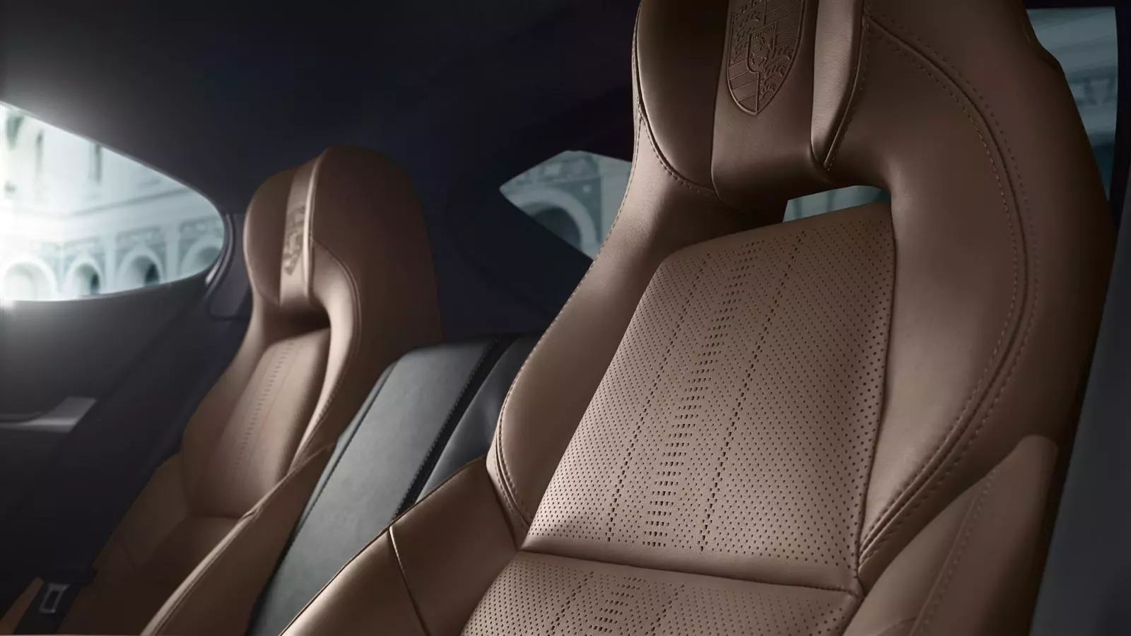 The Porsche crest imprinted on the headrests