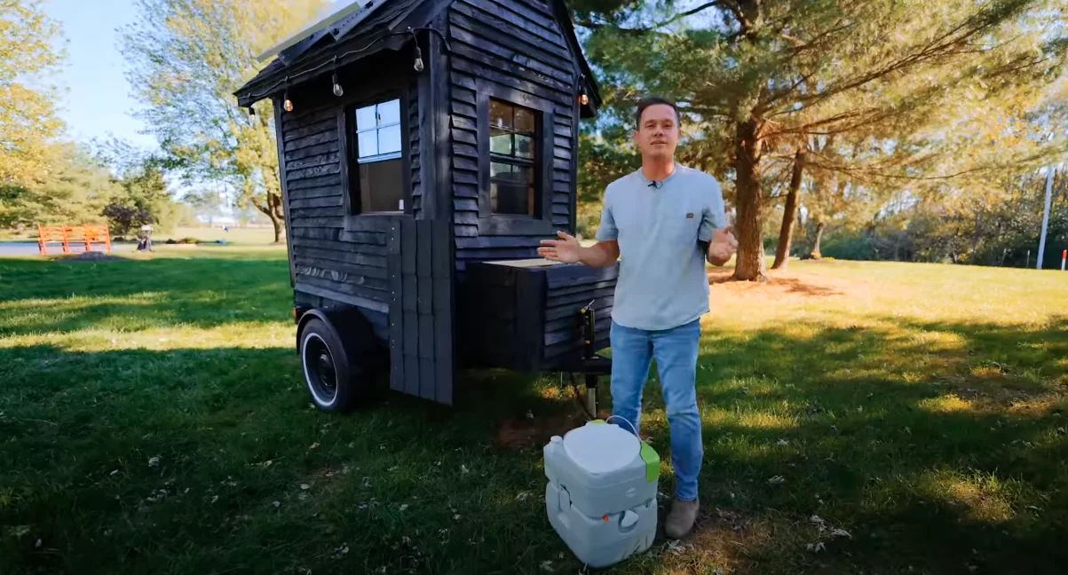 The tiny house features an outdoor toilet but it can be moved inside for privacy if preferred