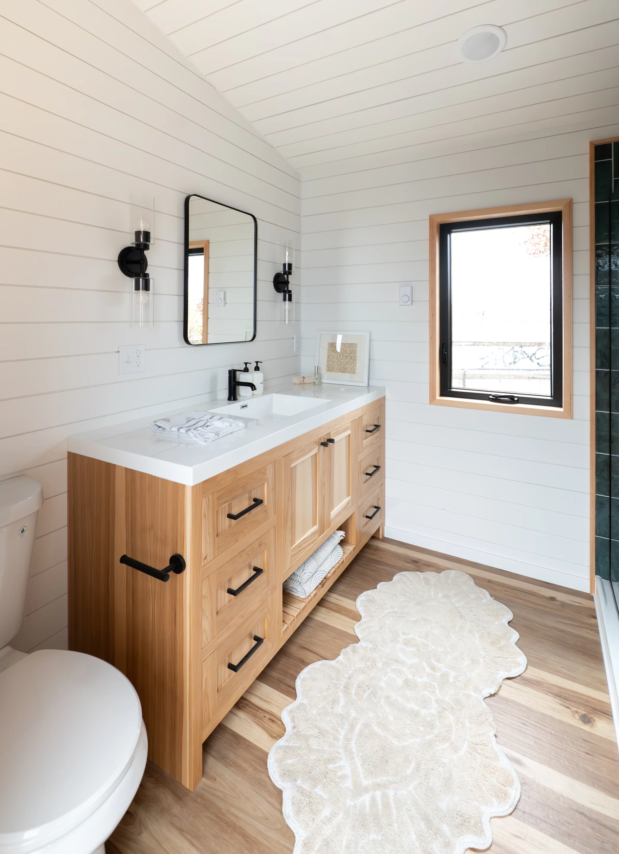 The Urban Park Max 37's bathroom includes a flushing toilet, a sink, a vanity sink, and a walk-in shower