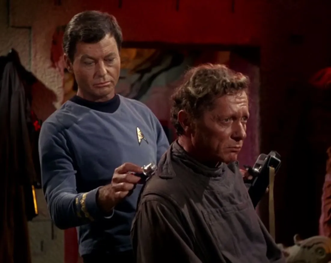 Dr McCoy using his medical scanner and tricorder