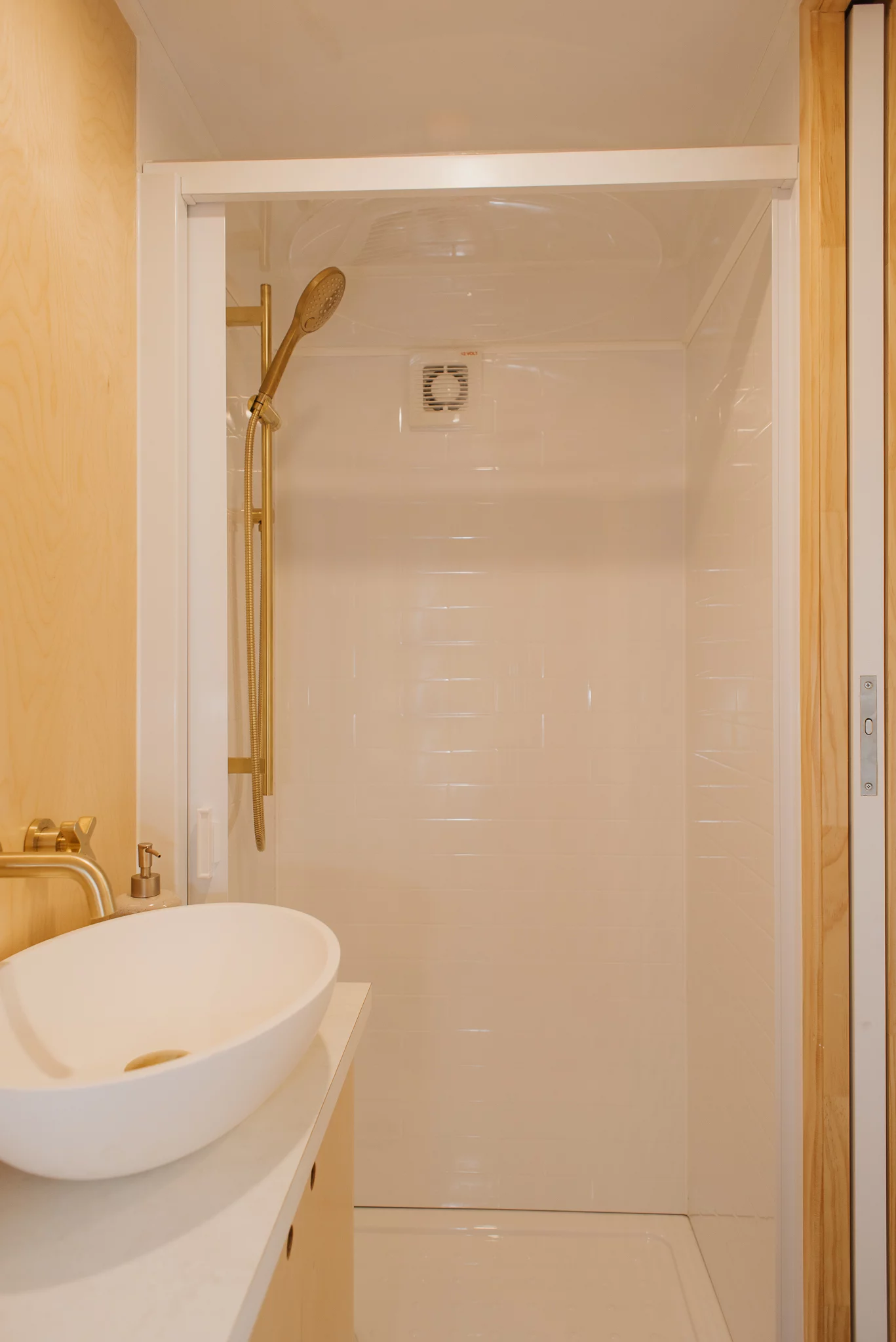 The Kererū Tiny House's bathroom includes a shower and sink