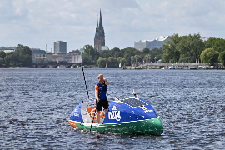At a press event in Hamburg, Michael Walther paddles his ocean-going SUP across Outer Alster Lake