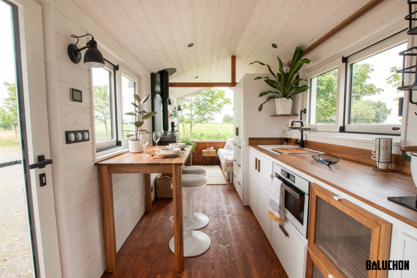 The Moulinsart's kitchen includes an oven and two-burner propane-powered stove