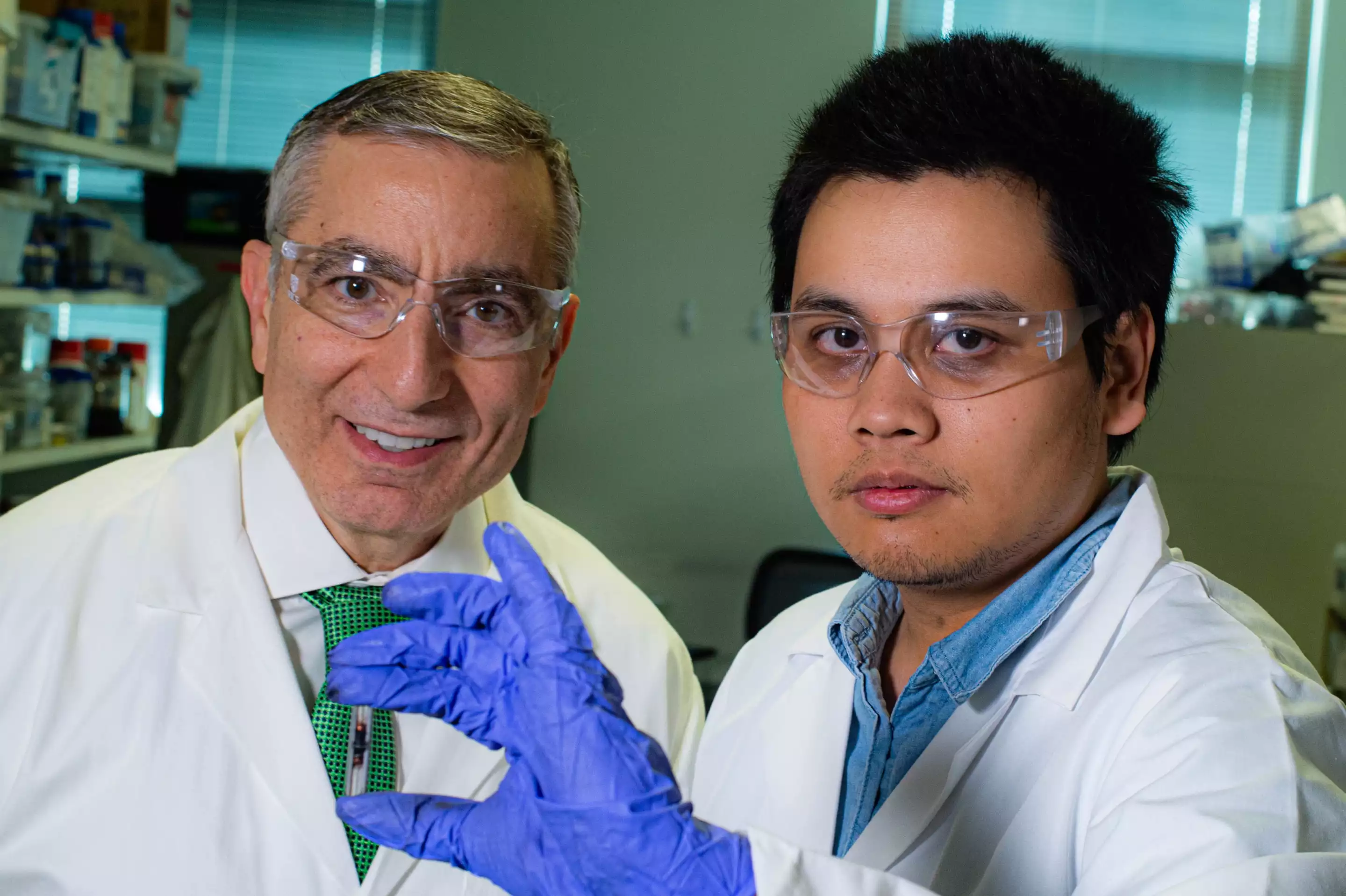 Rice University chemist James Tour, left, and graduate student Duy Luong with a sample of their flash graphene