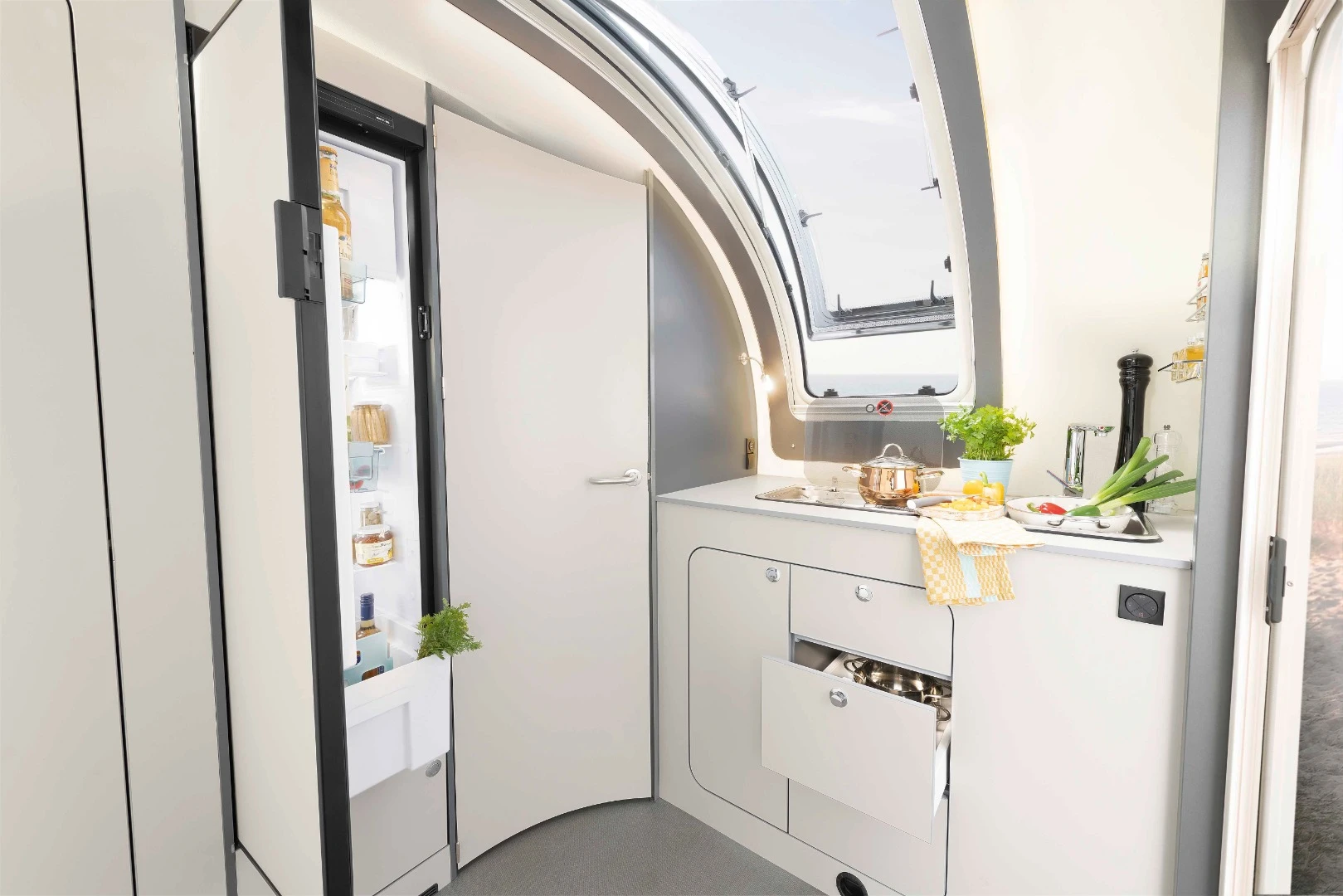 Front kitchen with large skylight/window and tall 142-L fridge