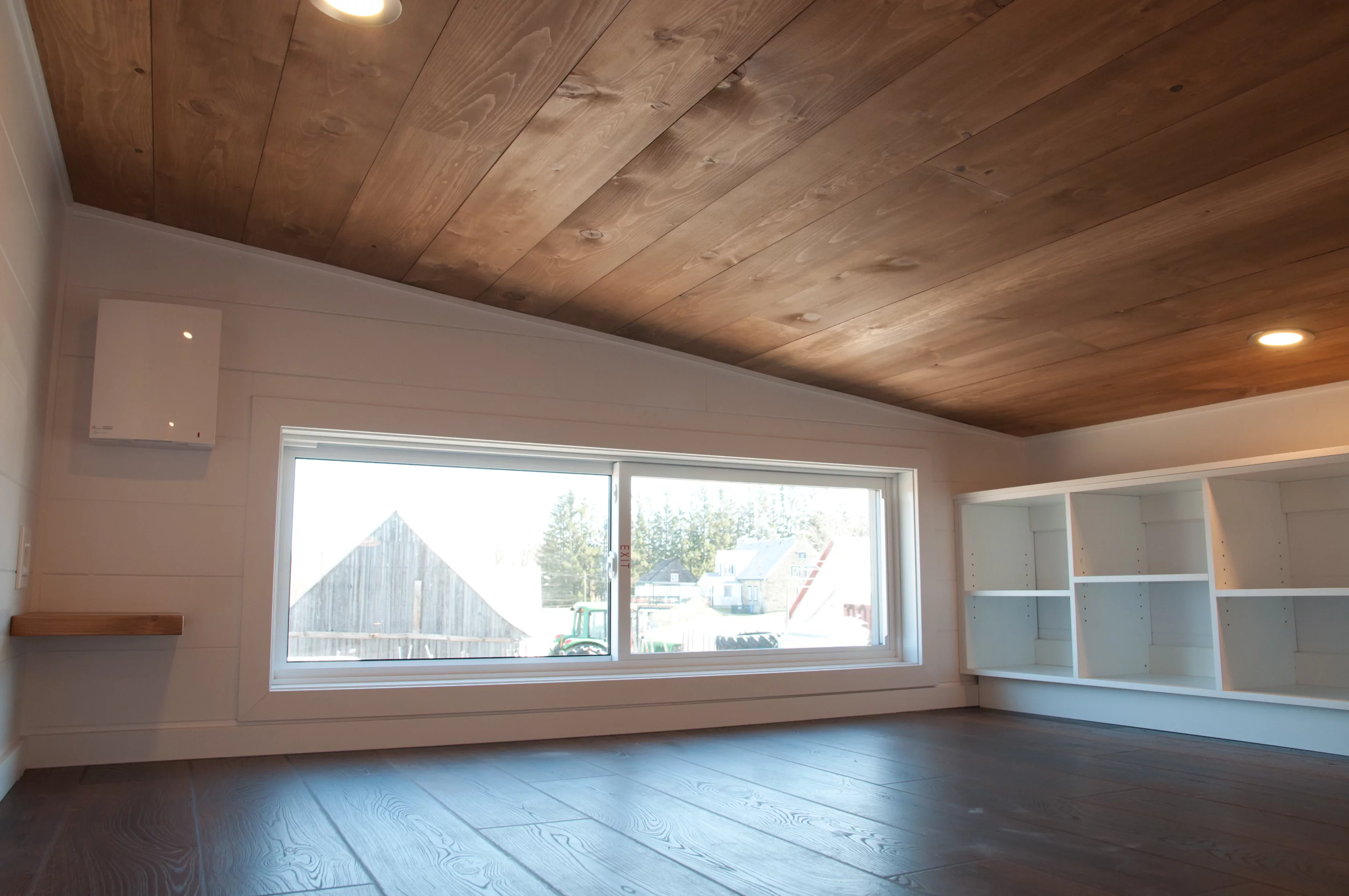 The bedroom includes an emergency egress window, and some storage space