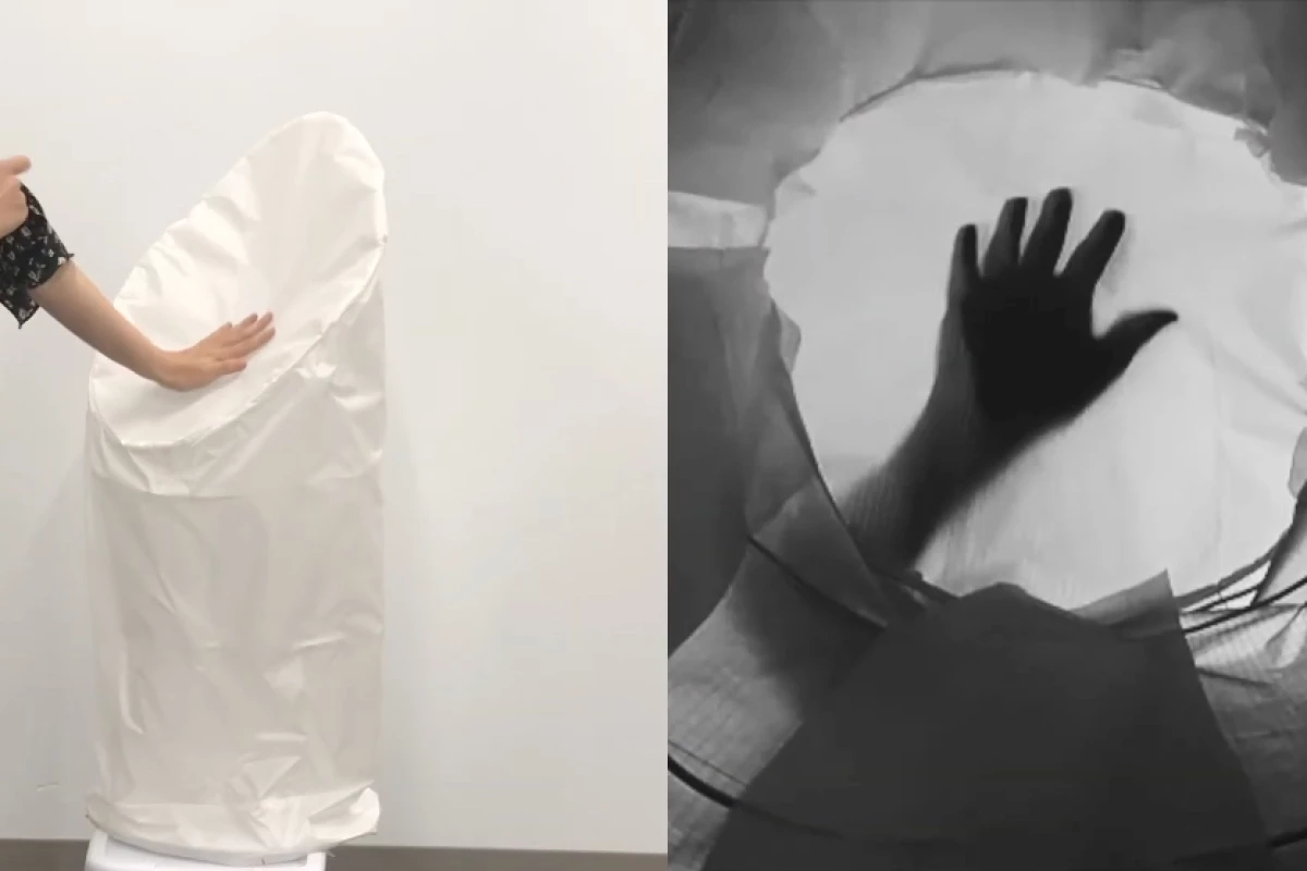 The ShadowSense prototype "sees" the shadow of a user's hand (right) as they touch the robot's skin