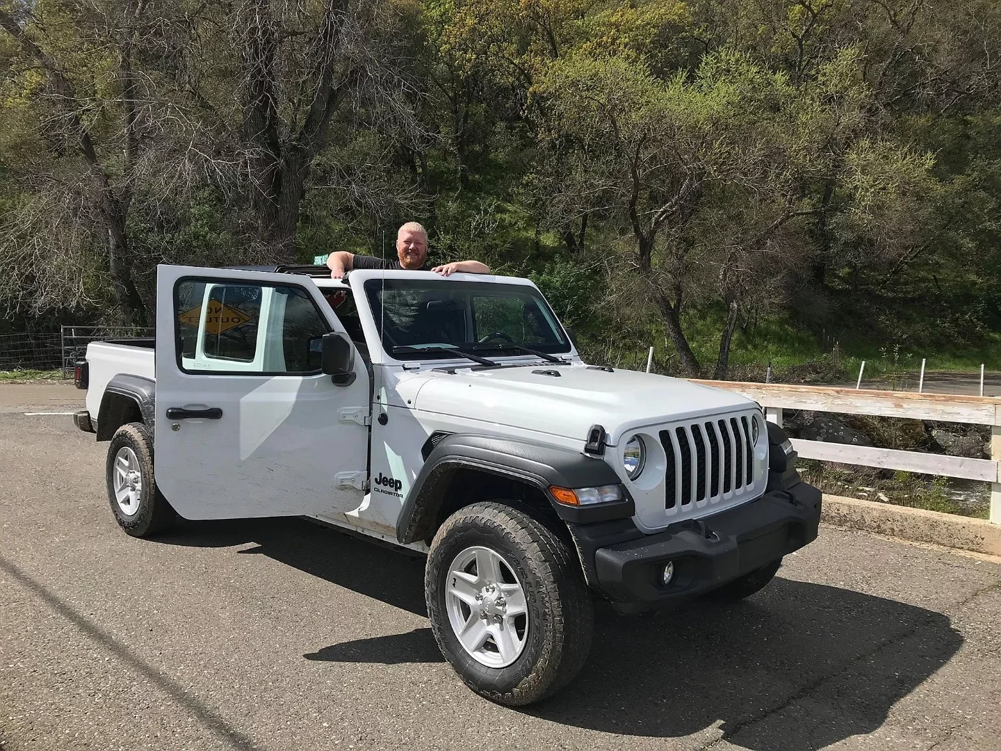 On hard top models, such as this Gladiator Sport S, the forward roof panels can be removed without tools, as the author demonstrates here
