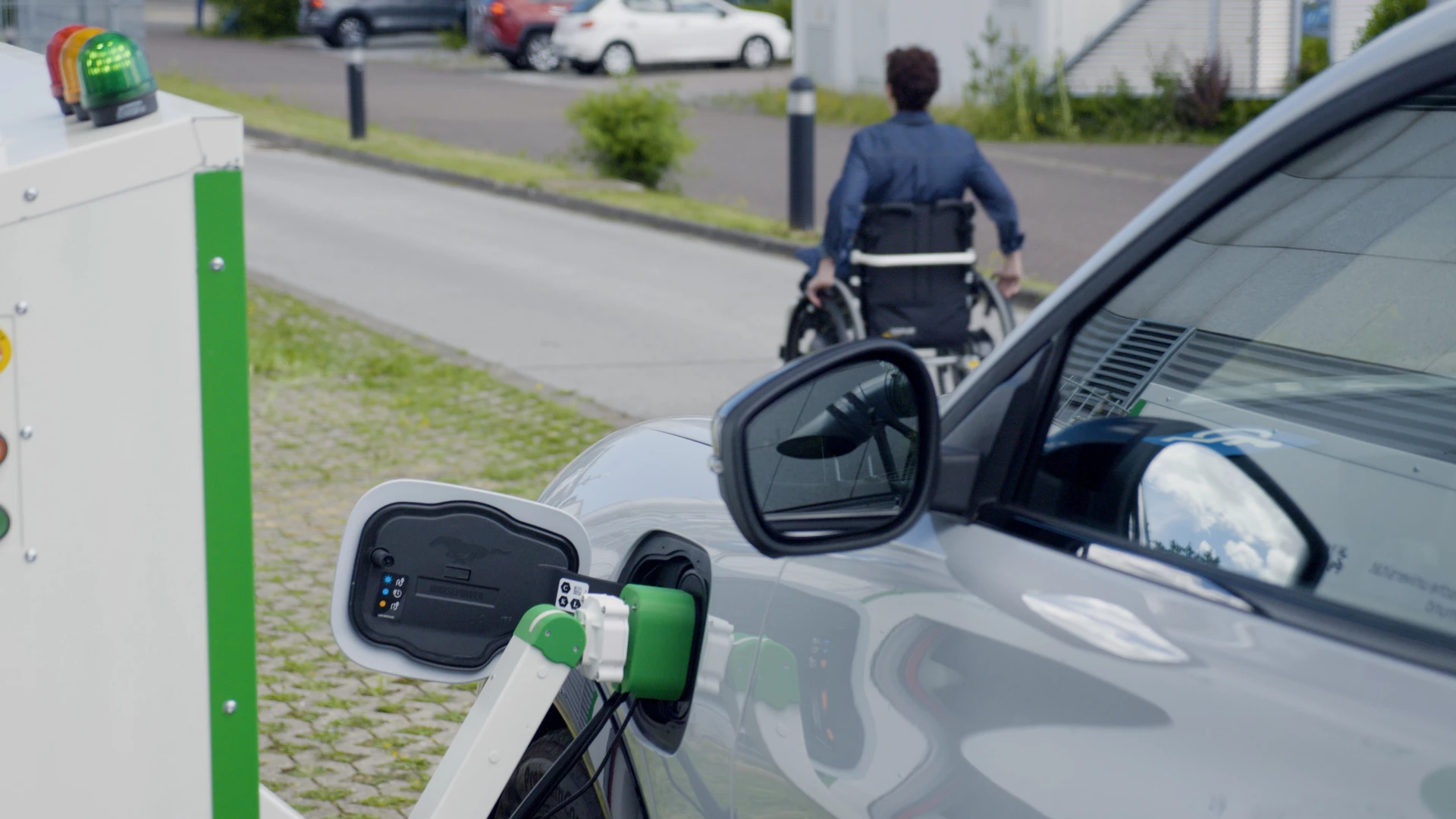 The automated charging process is initiated using a mobile, allowing a disabled EV driver to remain in the vehicle during a top up or exit the vehicle and return when the process has completed