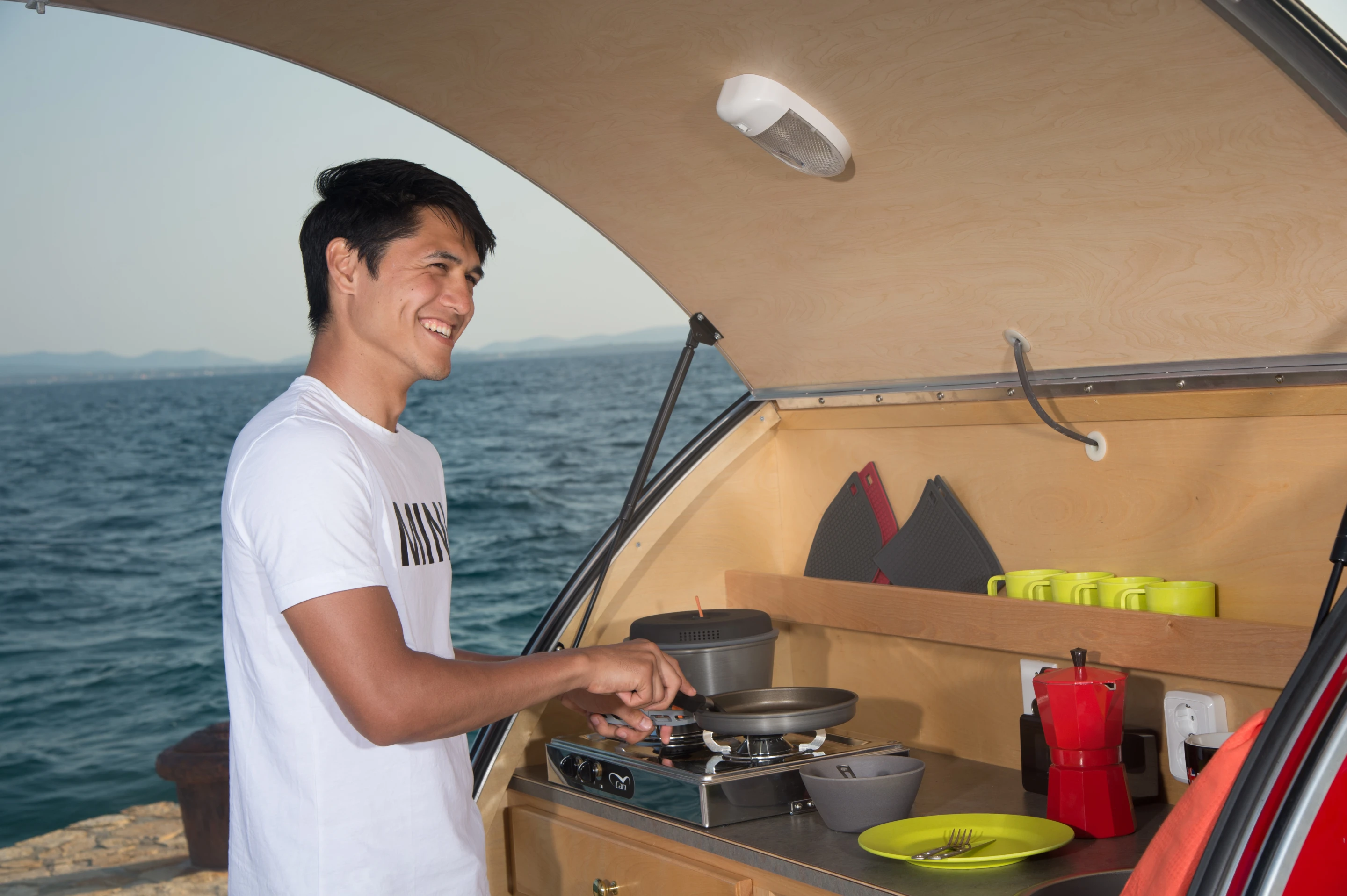 Cunningly, MINI has opted to shift the kitchen to a compartment on the outside. This packs in a dual-burner gas stove, a sink with water tank and pump, and a refrigerator