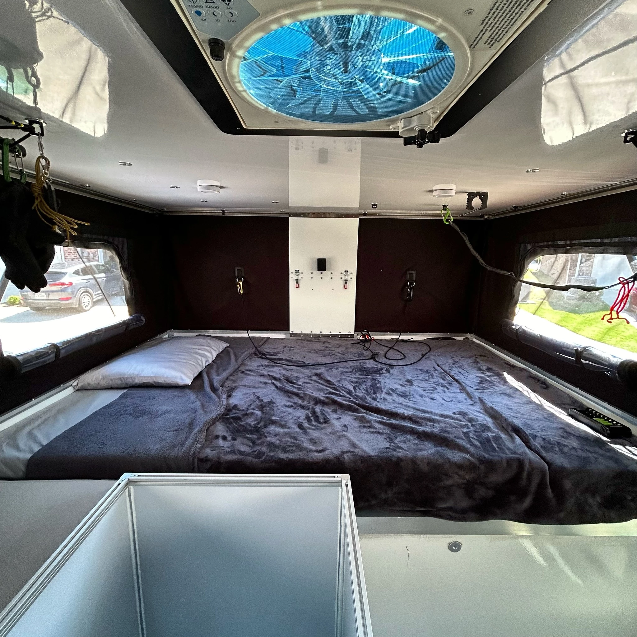 Each Stealth includes a 76 x 54-in double bed in the above-cab sleeper area; this one appears to have the wet bath in front of the bed