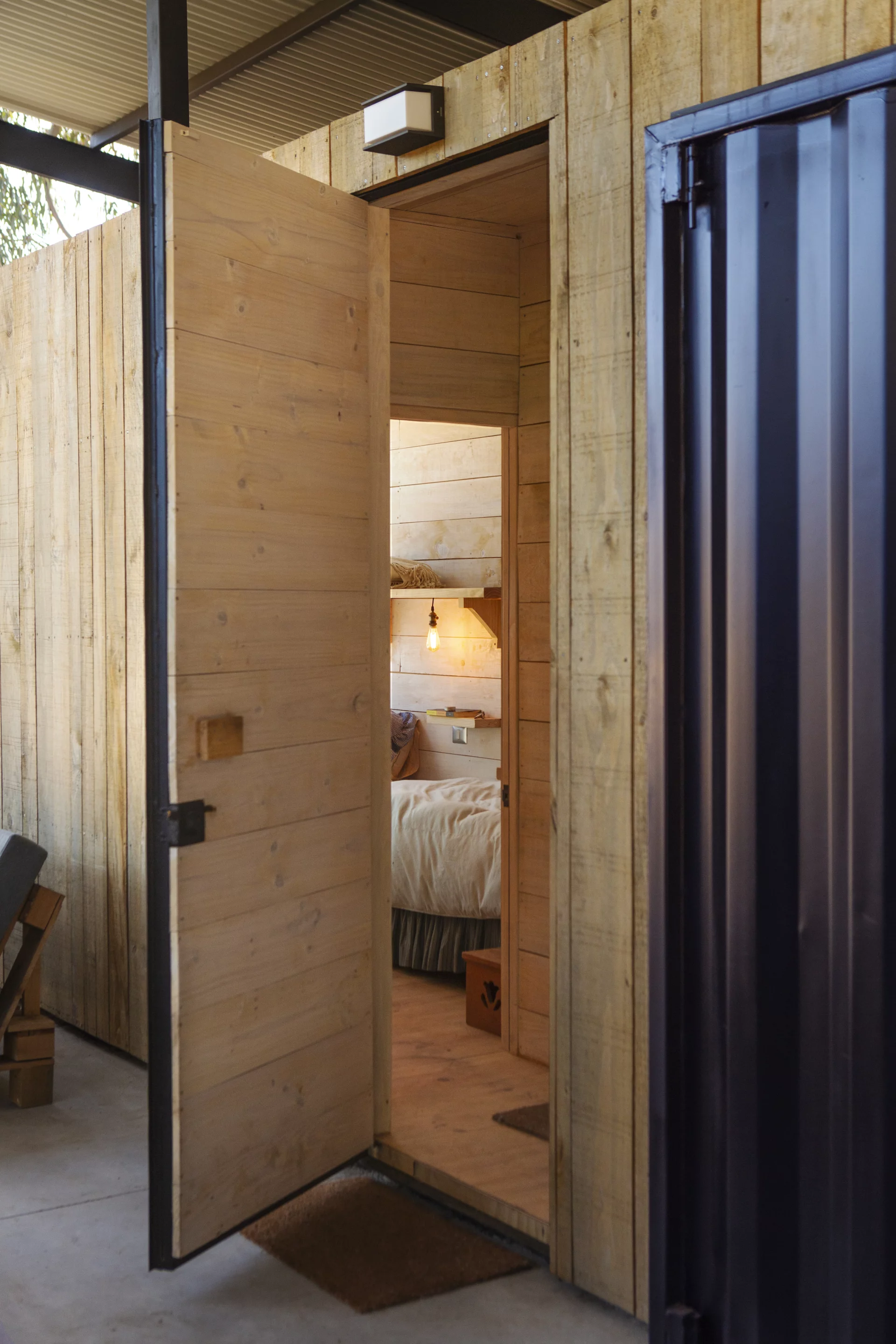 Container House consists of two shipping containers. One contains a bedroom, bathroom and living room, while the other is used for storage