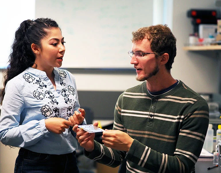 Graduate students Kiana Mirshahidi and Ben Wiltshire, with one of the sensors