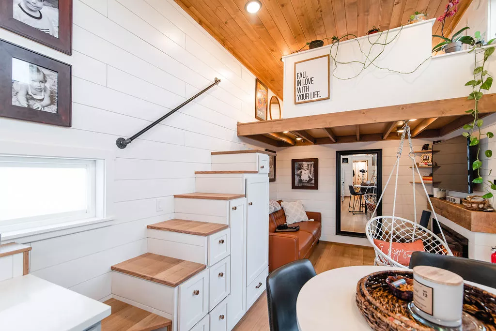 Jen's 34' x 10' Tiny Home has two loft bedrooms, which are reached by storage-integrated staircases