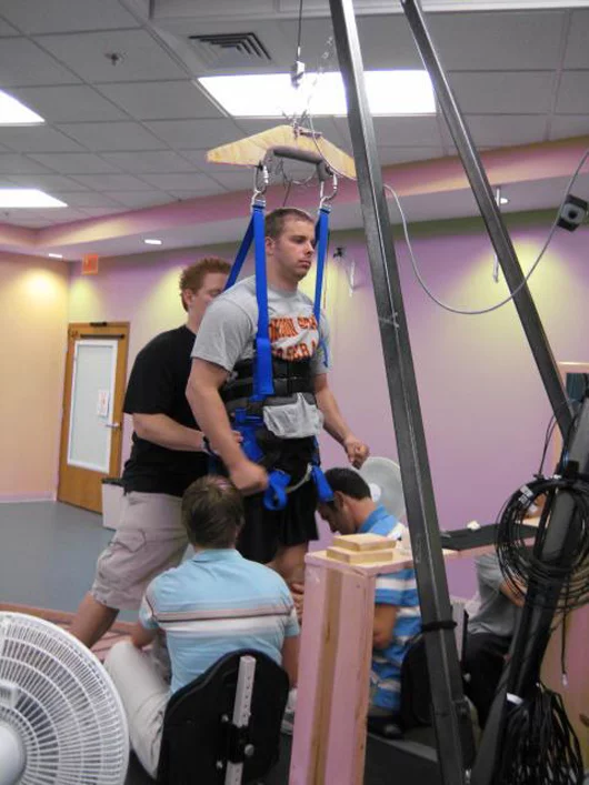 Rob Summers, 25, in the harness that provides support while he receives electrical stimulation to his spinal cord (Image: Rob Summers)
