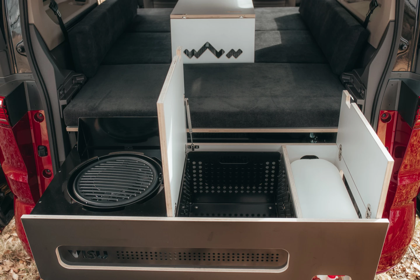 The grill/stove, water canister and storage compartment make up the kitchen