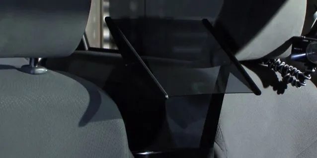 The half-mirror, which reflects the projected video onto the back seat