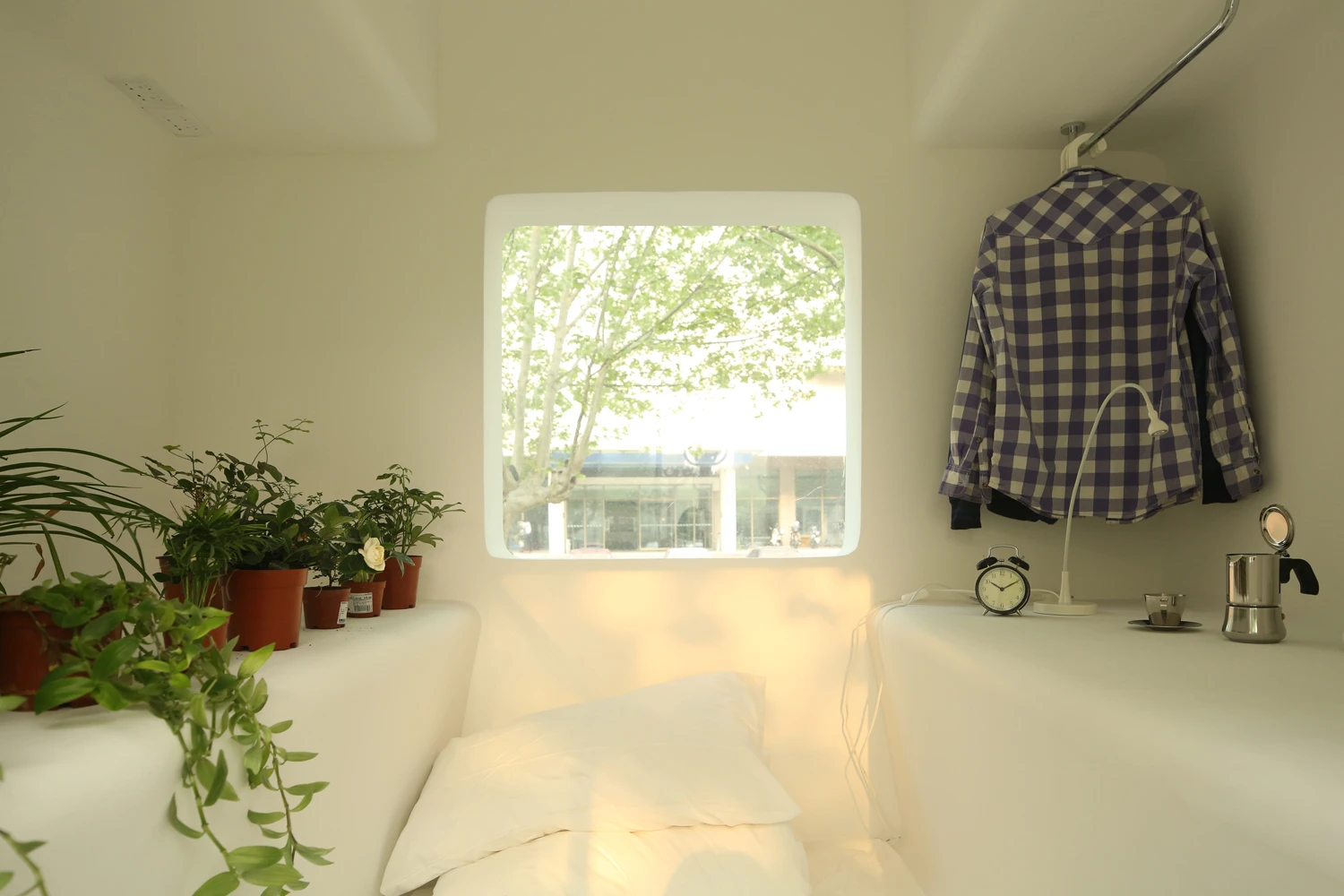 Each modular unit incorporates all interior furnishings into its main architectural structure, including bookshelves, clothes racks, seating and bedding