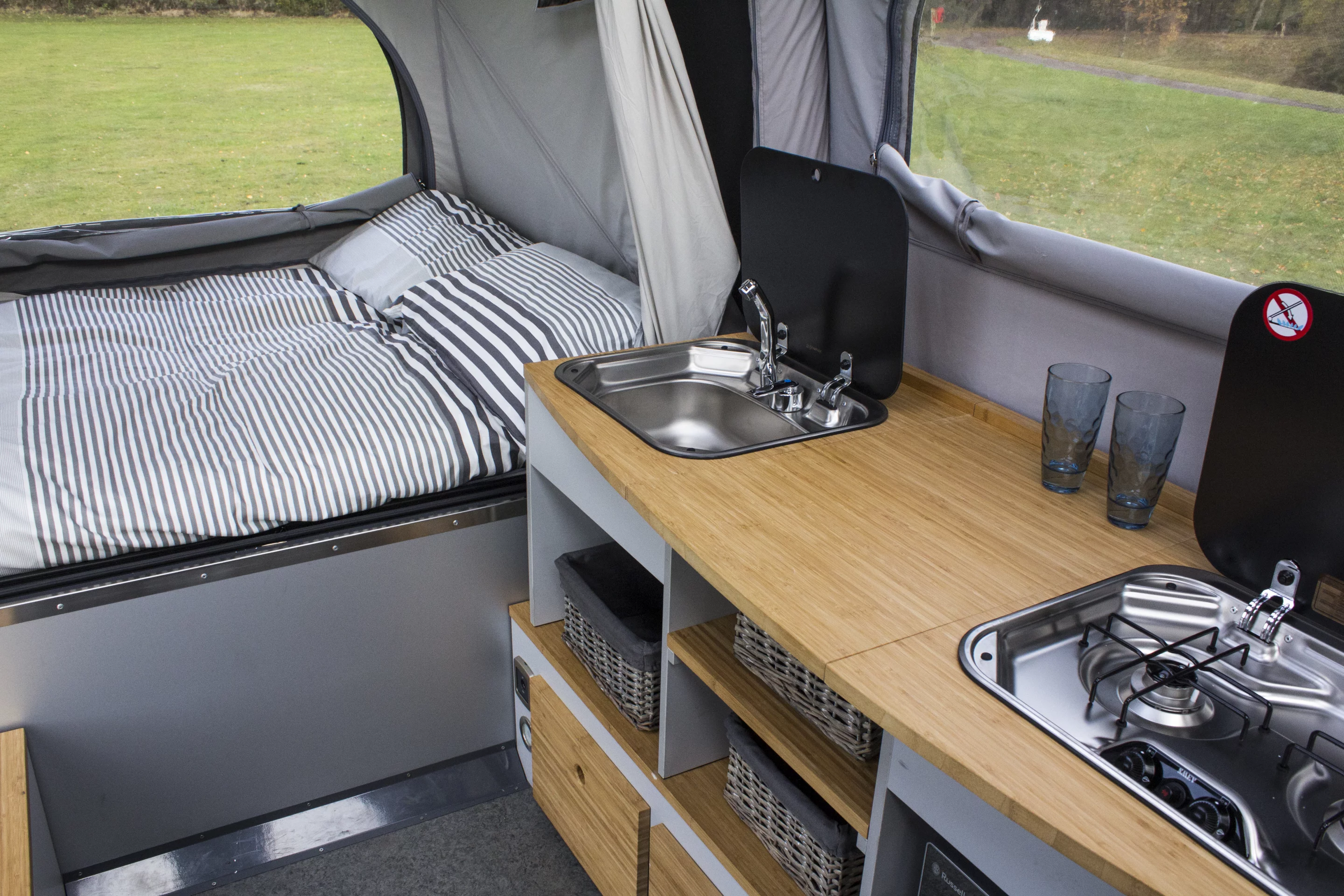 The kitchen has a dual-burner stove, worktop, sink and refrigerator