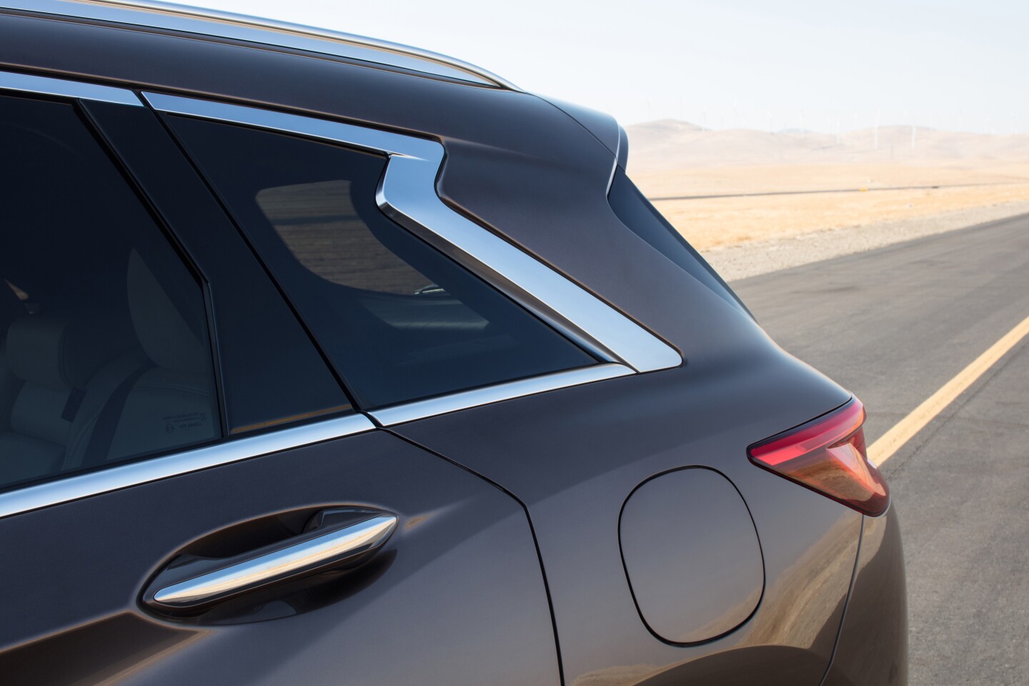 The hallmark crescent-cut D-pillar, a signature styling cue that is found across various Infiniti models