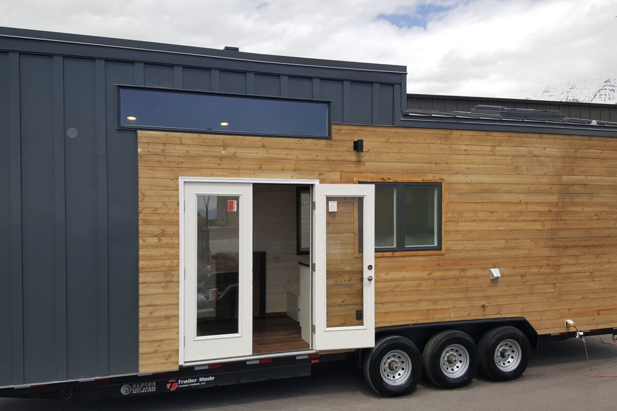 The tiny house measures 30 ft (9 m)-long and is based on a triple-axle trailer