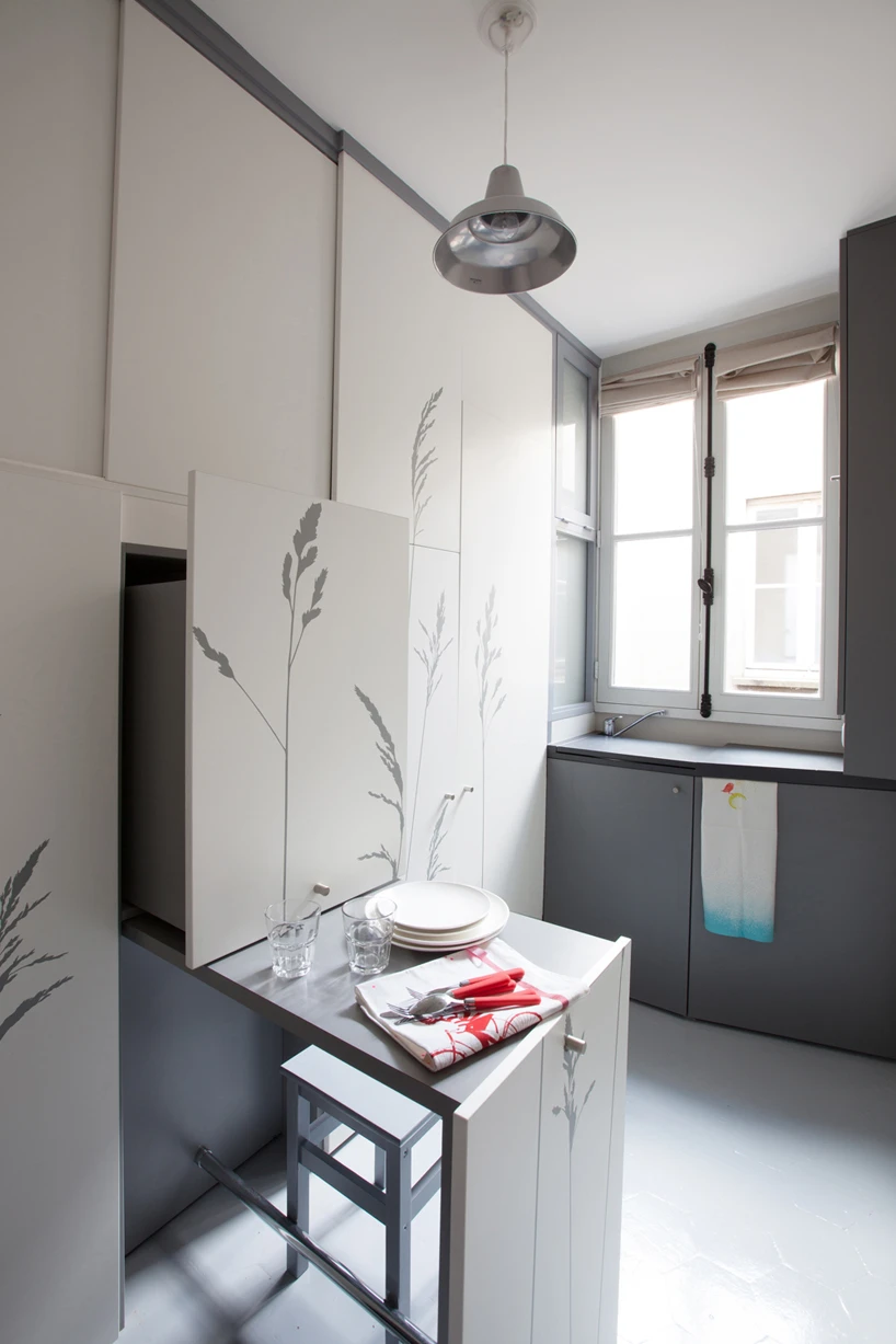 Two stools are stored within the the pull-out workspace-cum-table unit (Photo: Fabienne Delafraye)