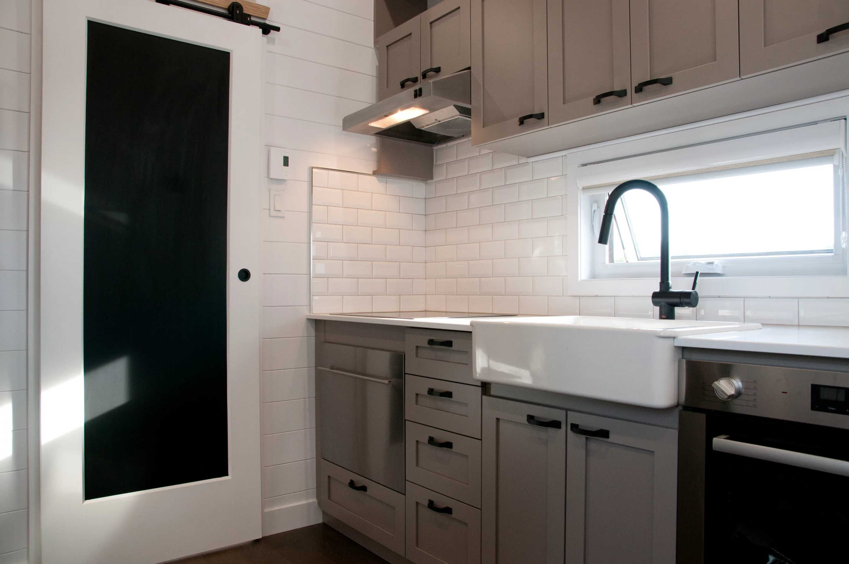 The Magnolia V6's kitchen includes a dishwasher, which is a rare luxury in a tiny house