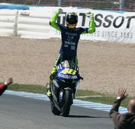 The trademark Rossi victory stance on the Yamaha M1