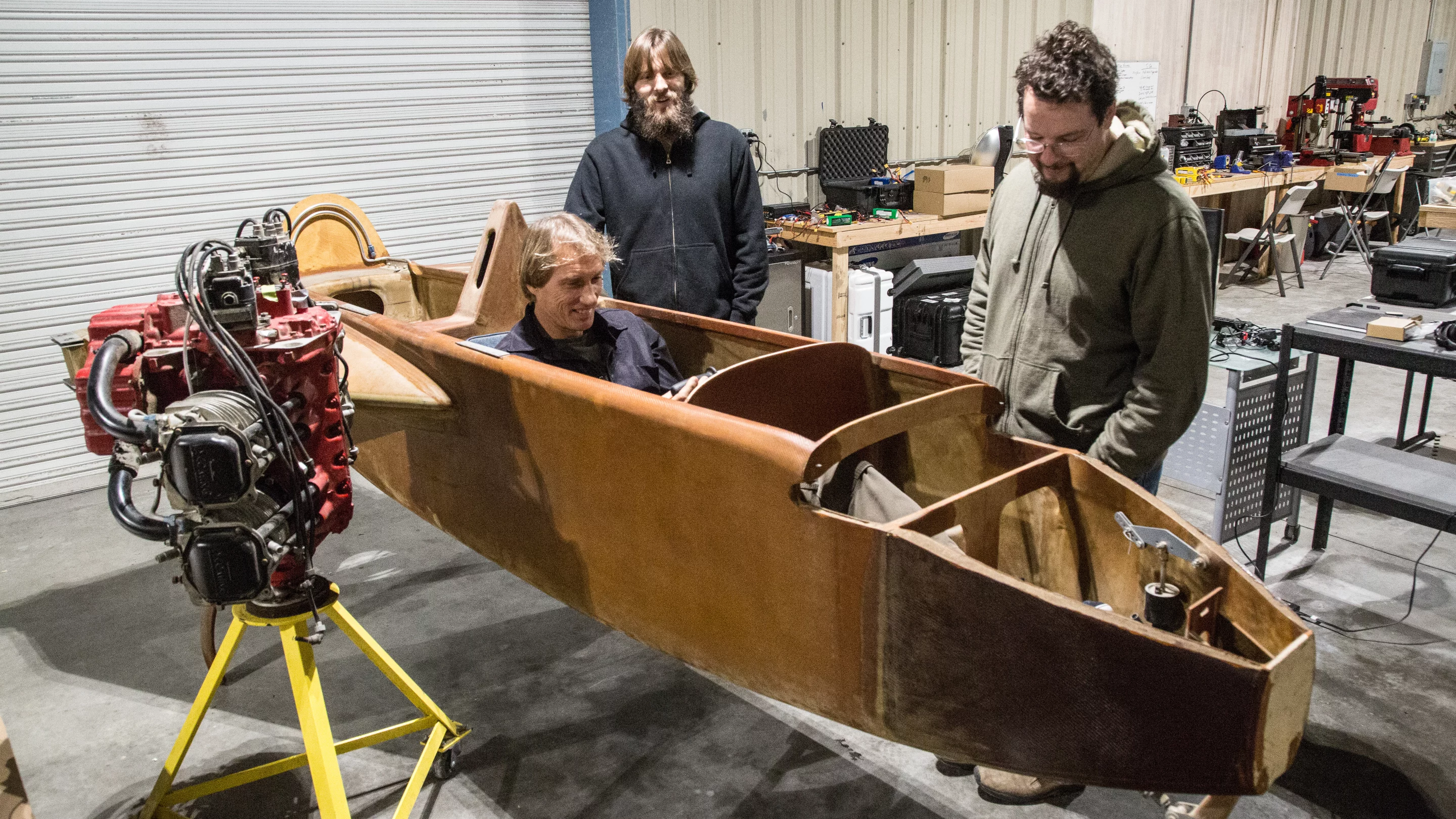 Dezso Molnar checks out the aircraft chassis he's converting to electric with Craig Calfee. Also pictured: Luke Workman and Gabe DeVault, who are spearheading the power plant integration.