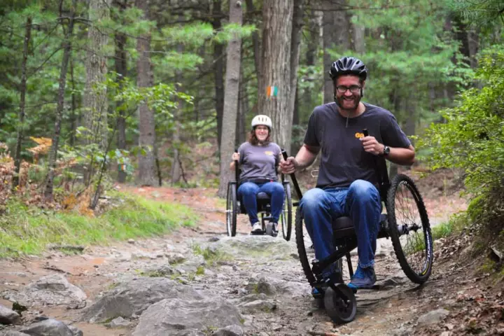 The Freedom Chair's knobby bike tires and torque-increasing lever drive help it navigate rough terrain