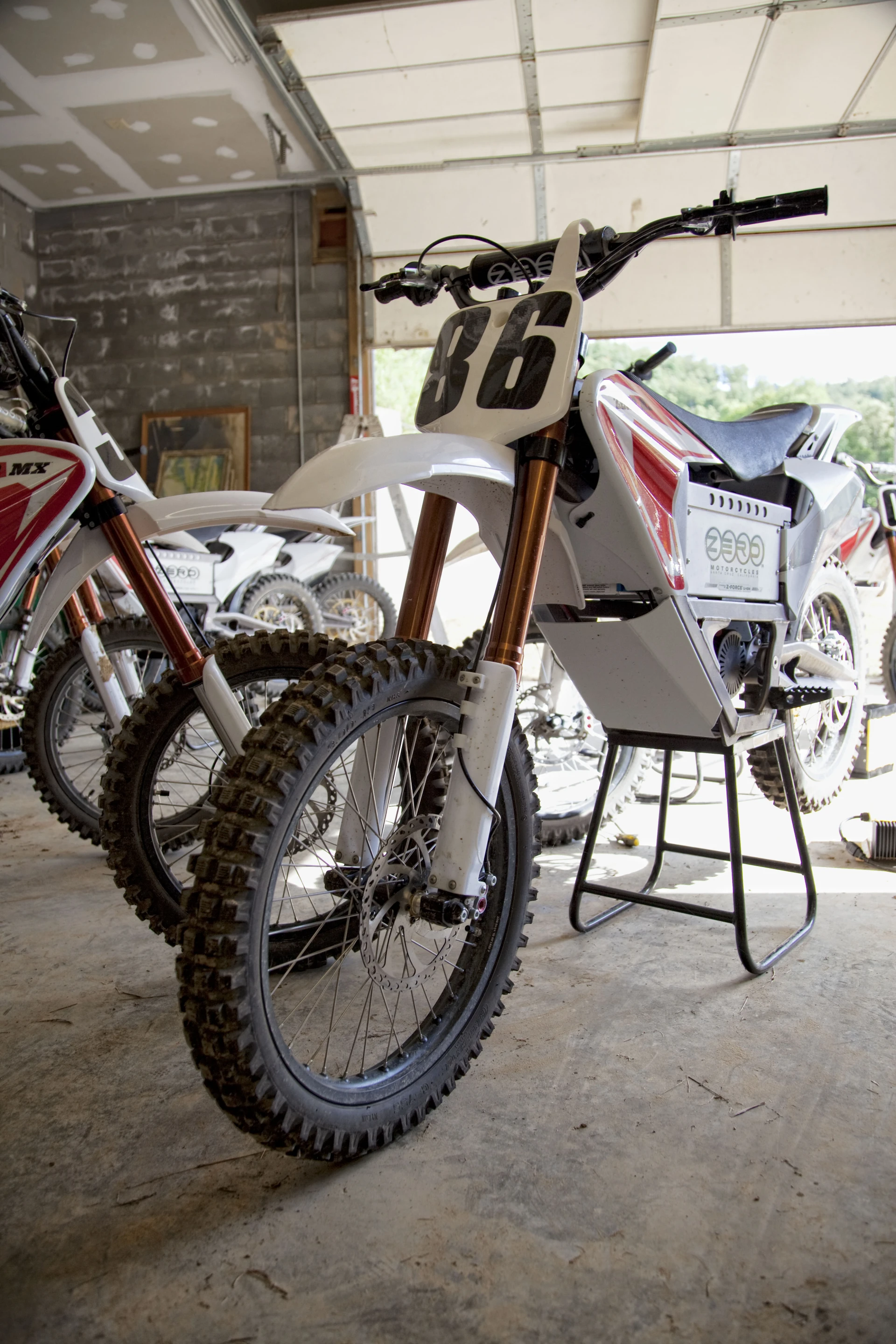 Cleaned-up Zero MX rental bikes wait in the shop for hire