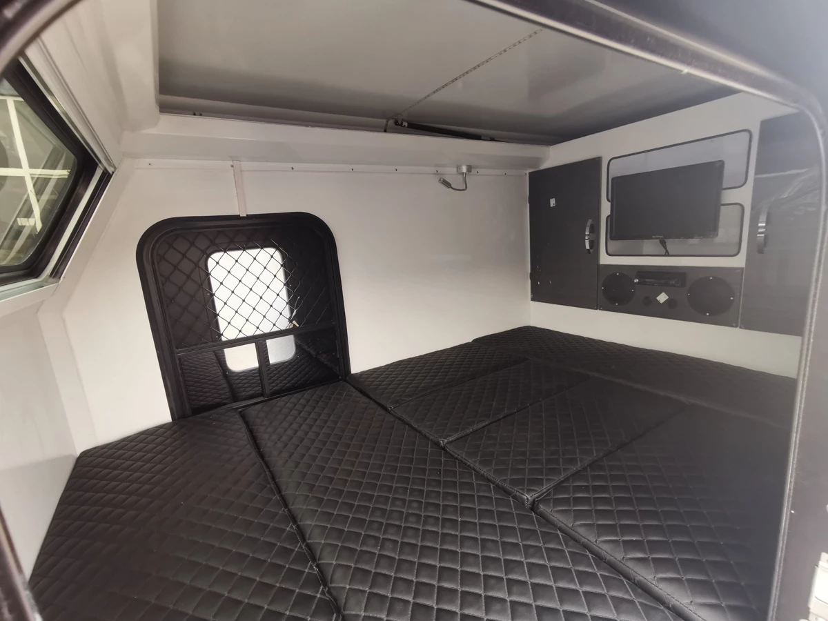 Valkari X1 converted over into sleeping configuration with main bed and rooftop sleeper platform and