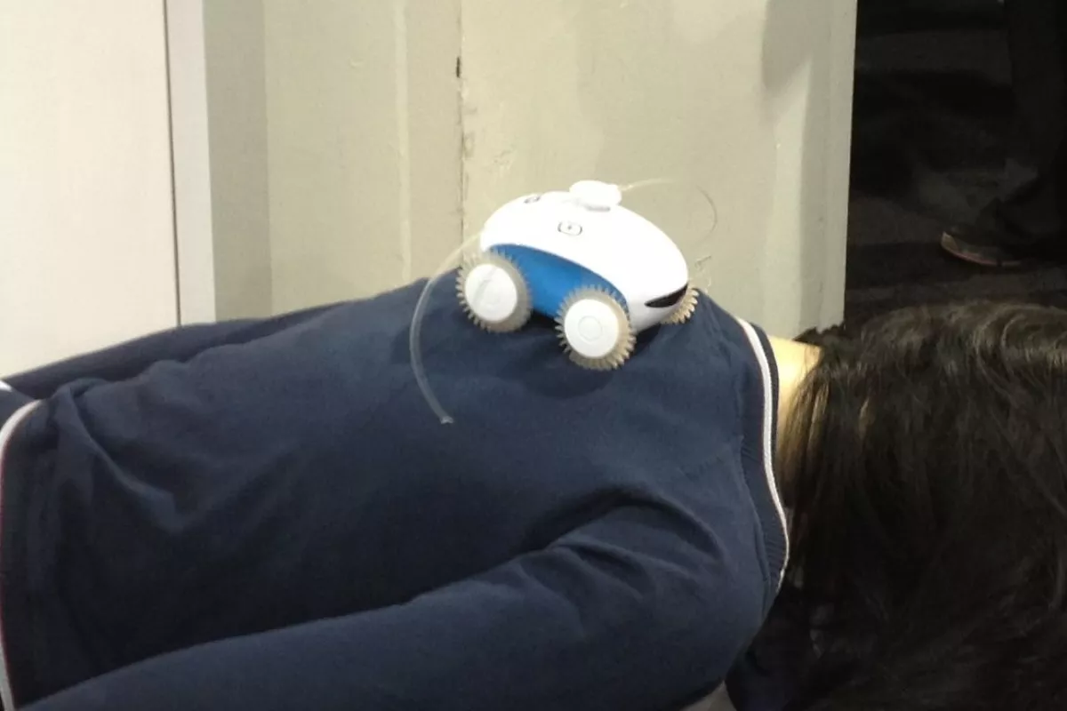 WheeMe giving a massage on the show floor of CES