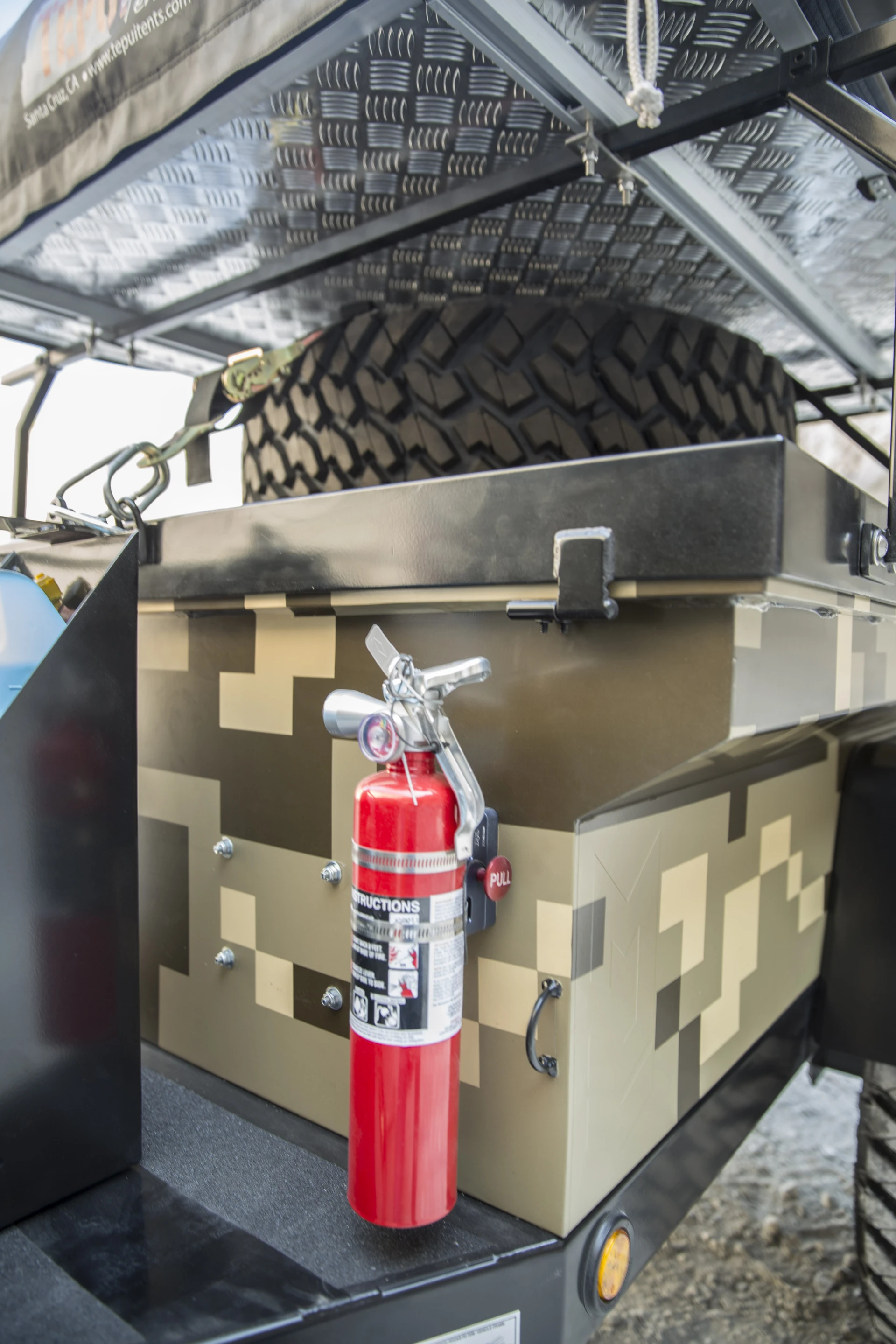 The trailer carries a spare tire, fire extinguisher and other supplies