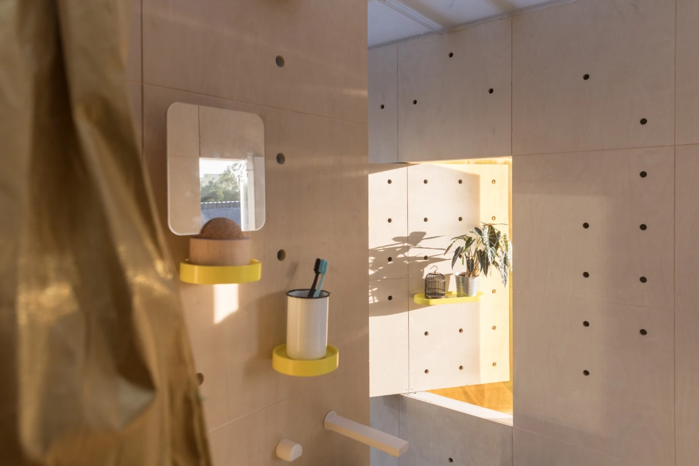 A look inside the Mini Living Urban Cabin Beijing features some of the same design elements seen on Mini’s Urban Cabin concept for LA, with rotating wall panels that swing up or around to create shelves and open interiors up to the outside