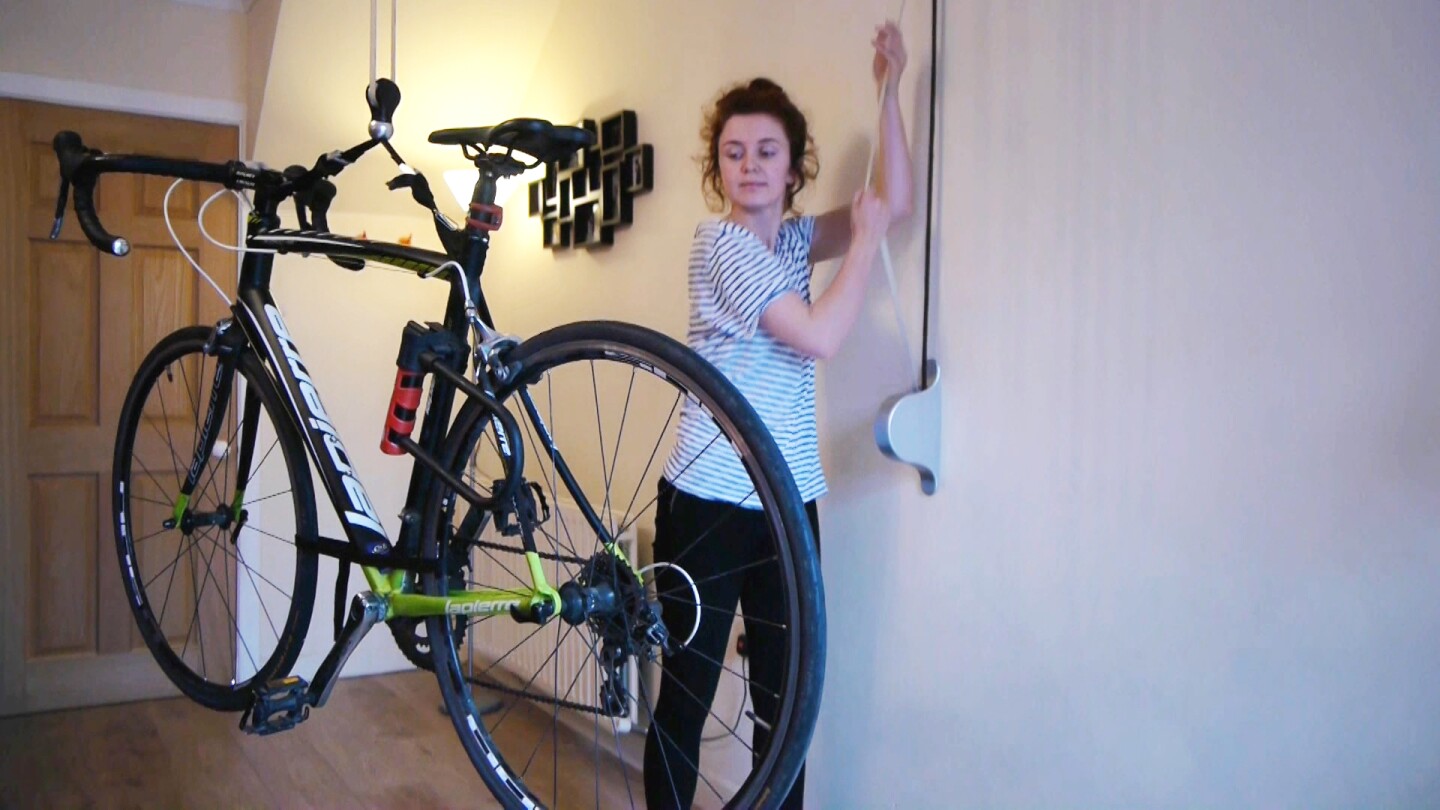 Stowaway users start by pulling on the strap to which both lopps are attached, which raises the bike straight up off the floor