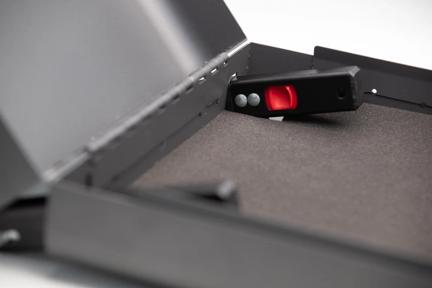 The Boosted Safe's slide-out latching mechanisms engage the car's booster seat attachment points