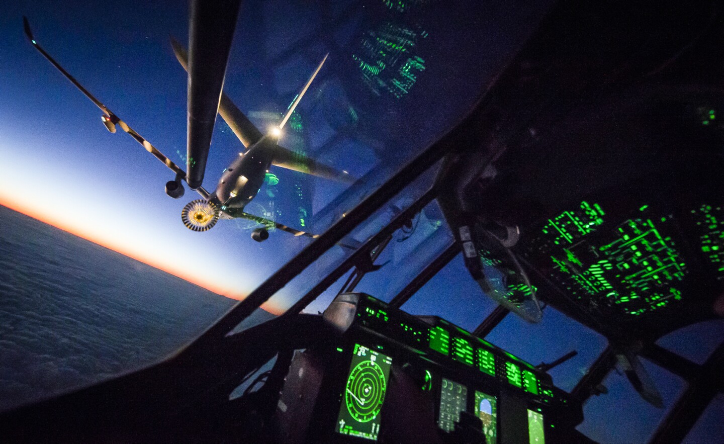 From Cpl Matty Matthews, 2nd Place in Photographer of the Year. This photo shows a Royal Air Force C130J Hercules refuelling with an Airbus Voyager Airtanker during a routine training sortie over the West Coast of England. The aircraft were taking part in an airborne delivery training sortie that saw them drop two different loads, ranging in weight from 100 kilograms to a tonne, over Abingdon, Oxfordshire. After completing that part of the sortie they then linked up to a Voyager to complete some low-light air to air refuelling over the West Coast of England.