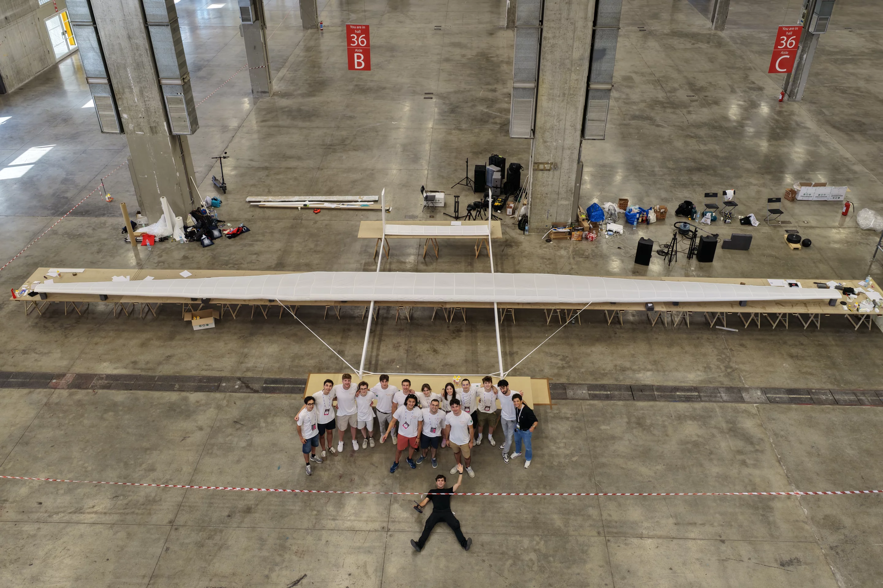 The Pisa team poses beneath ICARUS's 65.8-ft wingspan