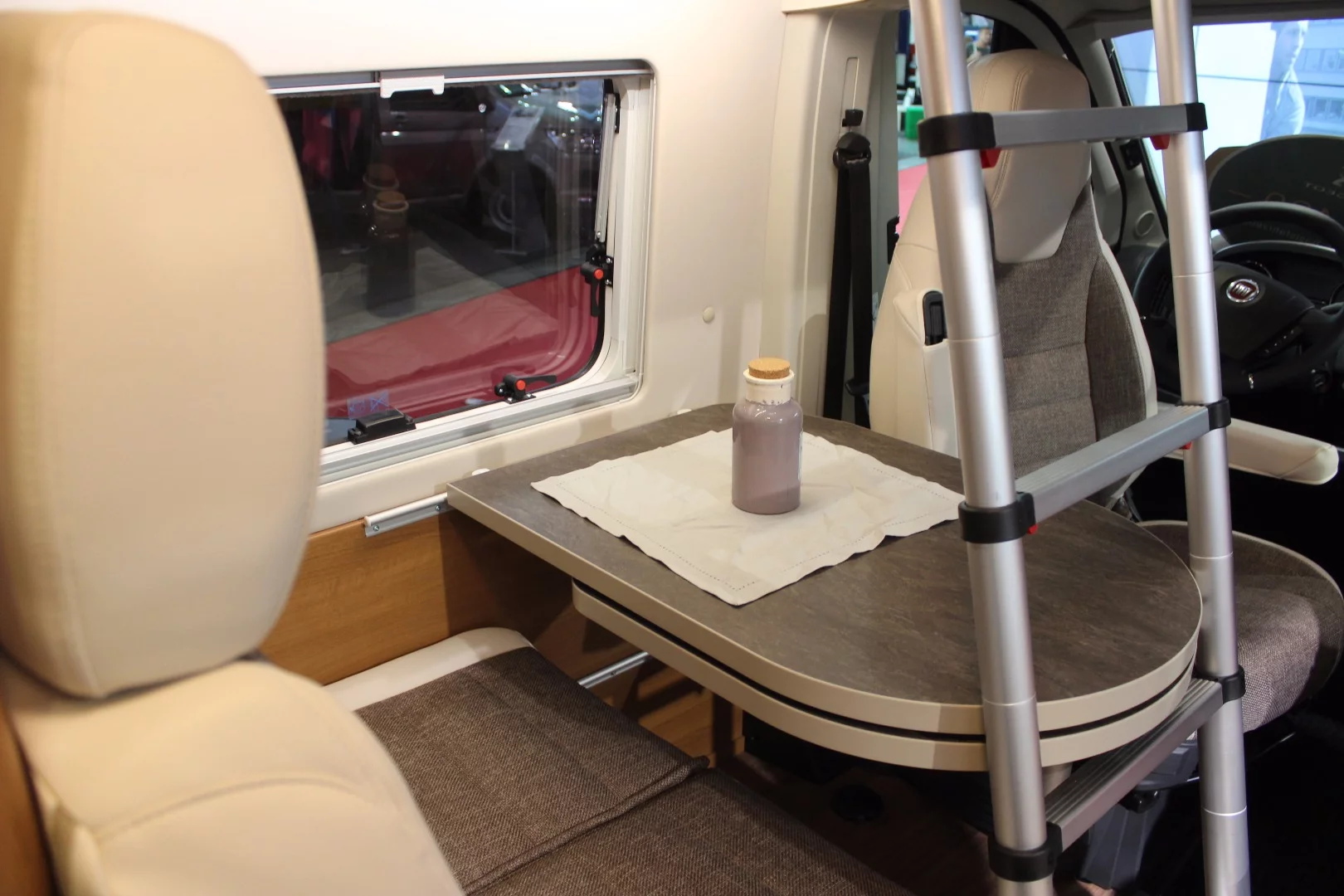 The lower table leaf swings below the upper to make room for the ladder but swings out to increase table space at dinner time